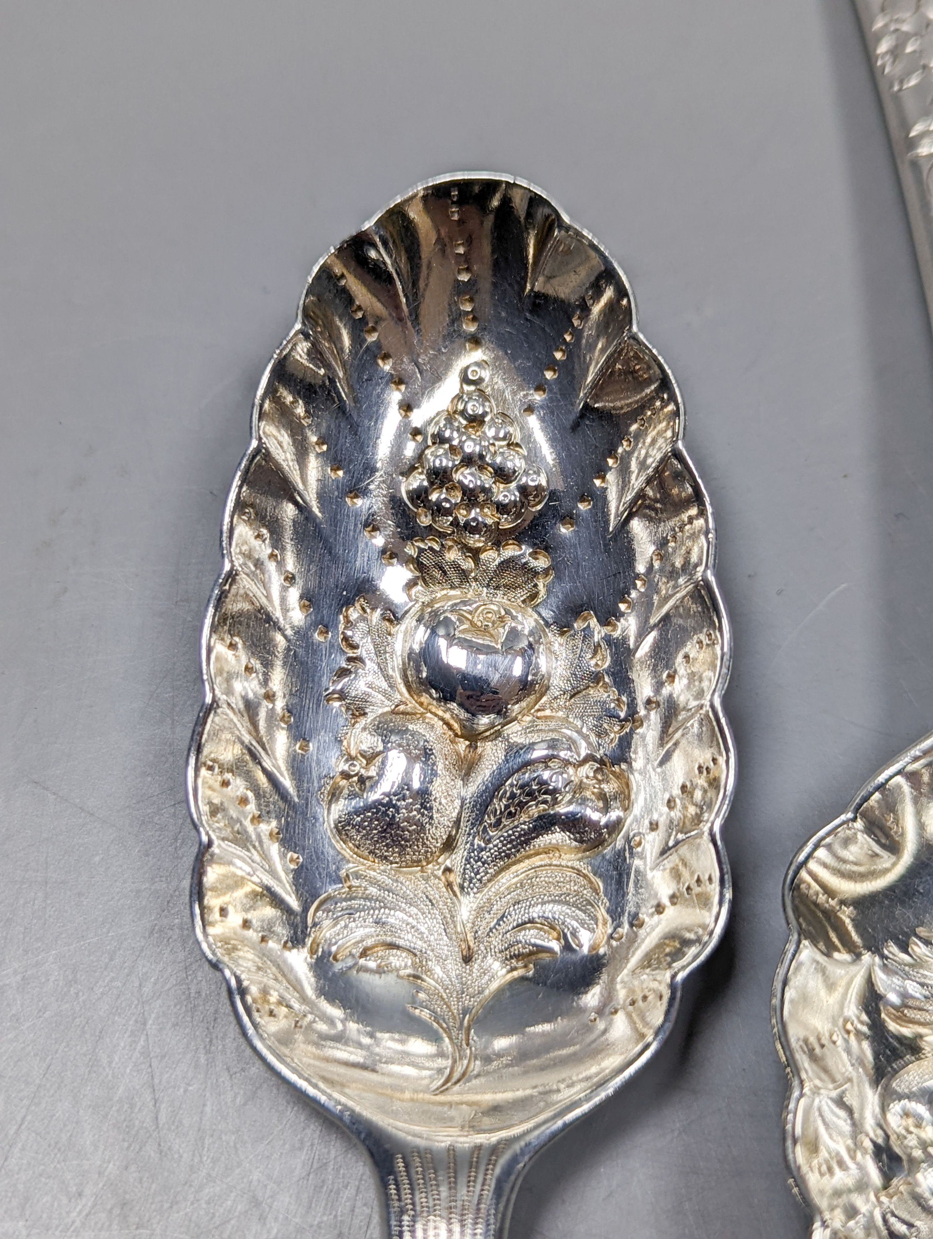 A pair of 18th century silver base mark 'berry spoons', marks pinched and sundry flatware including a Victorian silver pickle fork, a pair of silver sugar tongs, two 800 items of flatware and a pair Christofle plated sug